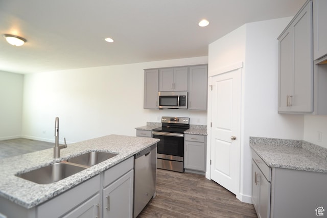 kitchen with a sink, gray cabinets, appliances with stainless steel finishes, and recessed lighting