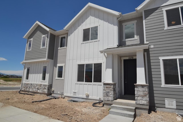 view of front of home featuring board and batten siding and stone siding