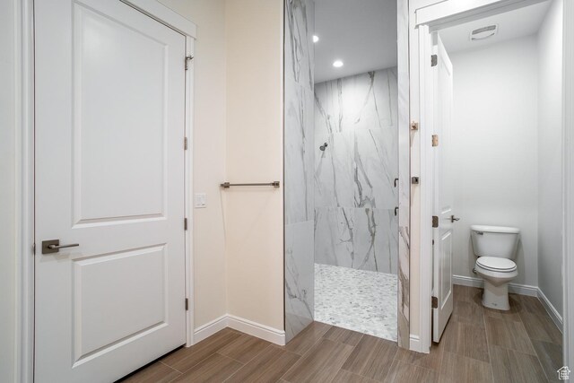 2889 E 1400 S, St George, UT 84790 - bathroom featuring wood finish floors, recessed lighting, toilet, a marble finish shower, and baseboards