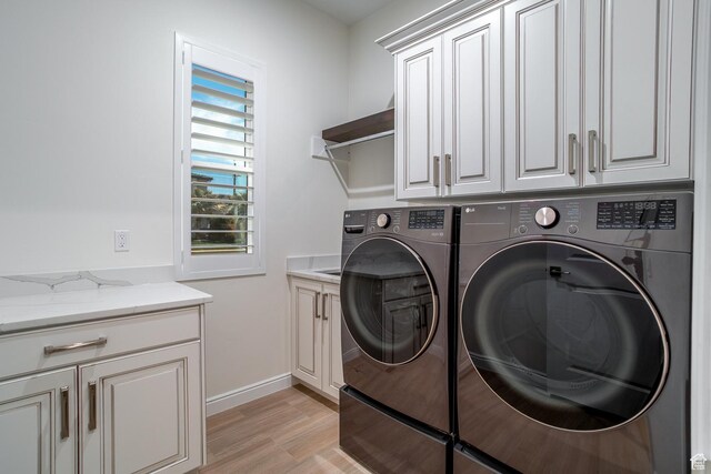 2889 E 1400 S, St George, UT 84790 - washroom with light wood-style floors, baseboards, cabinet space, and washing machine and dryer