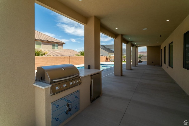 2889 E 1400 S, St George, UT 84790 - view of patio with a grill, a fenced in pool, fence private yard, and an outdoor kitchen