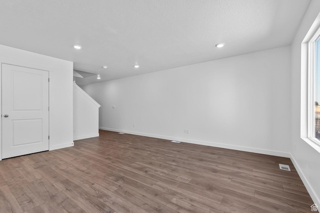 1748 S Windy Ridge Dr Unit 1281, Spanish Fork, UT 84660 - unfurnished living room with visible vents, baseboards, recessed lighting, and wood finished floors
