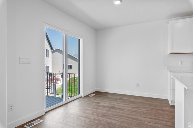 1748 S Windy Ridge Dr Unit 1281, Spanish Fork, UT 84660 - unfurnished dining area featuring wood finished floors, baseboards, and visible vents