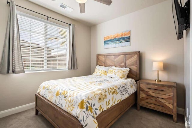 carpeted bedroom featuring visible vents, baseboards, and ceiling fan