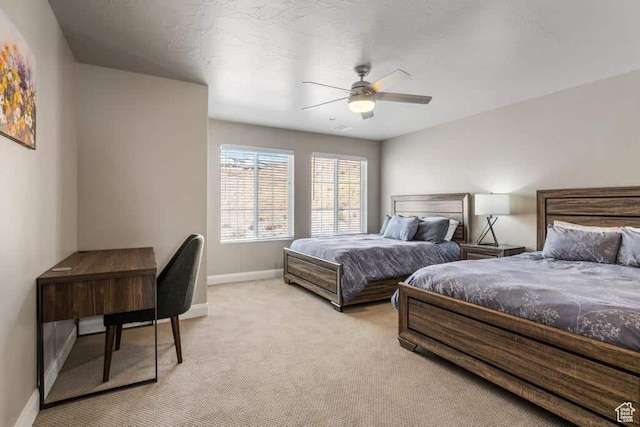 bedroom with baseboards, ceiling fan, and light colored carpet