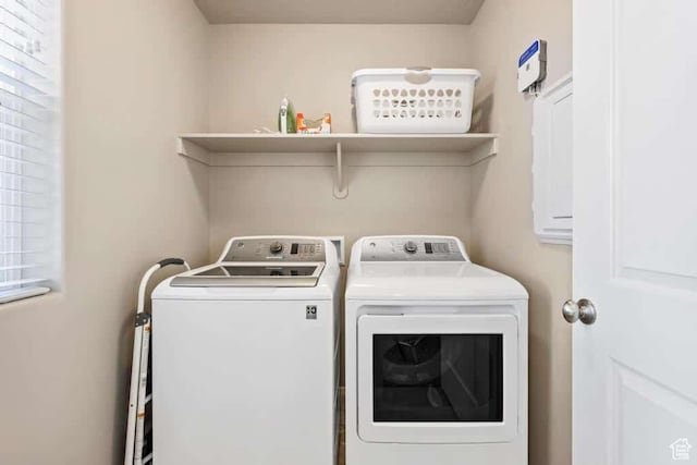 clothes washing area with washer and dryer and laundry area
