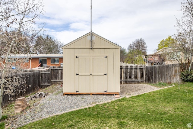 view of shed with a fenced backyard
