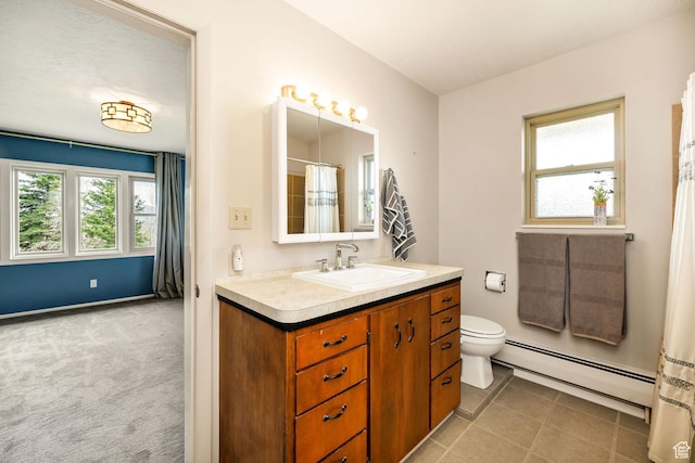bathroom with vanity, a baseboard heating unit, baseboards, tile patterned flooring, and toilet
