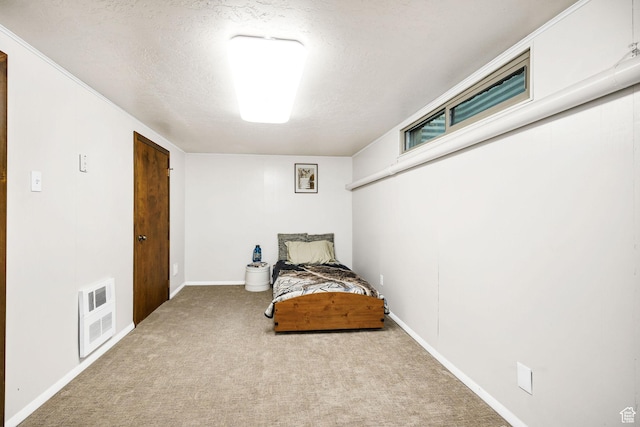 carpeted bedroom featuring a textured ceiling, baseboards, and visible vents