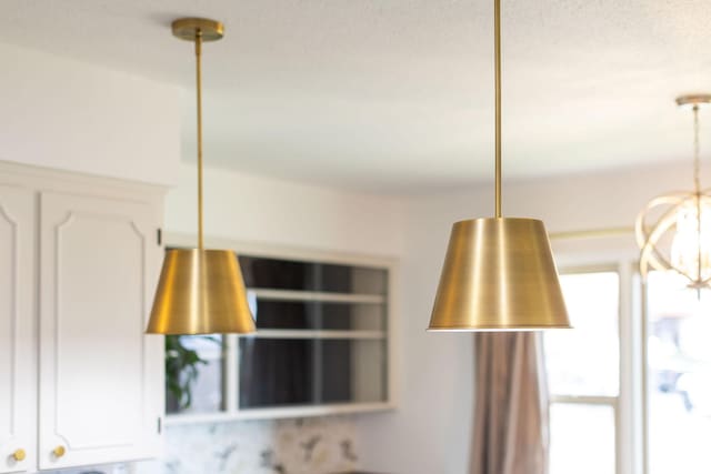 details with white cabinetry and a notable chandelier