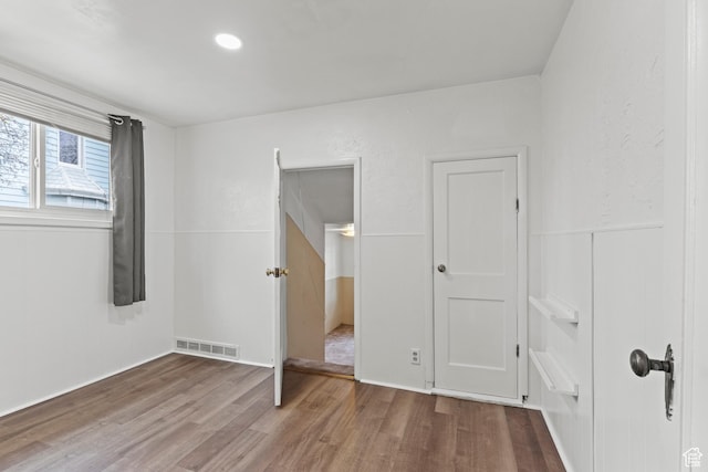 180 S 300 E, Logan, UT 84321 - unfurnished bedroom with visible vents and wood finished floors