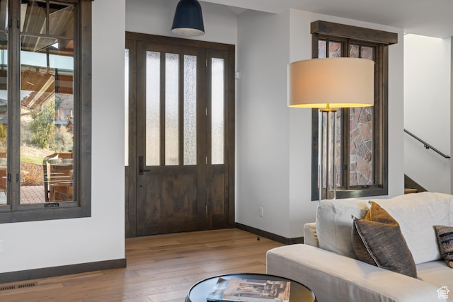 entrance foyer featuring wood finished floors, baseboards, and visible vents