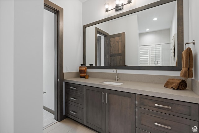bathroom featuring recessed lighting and vanity