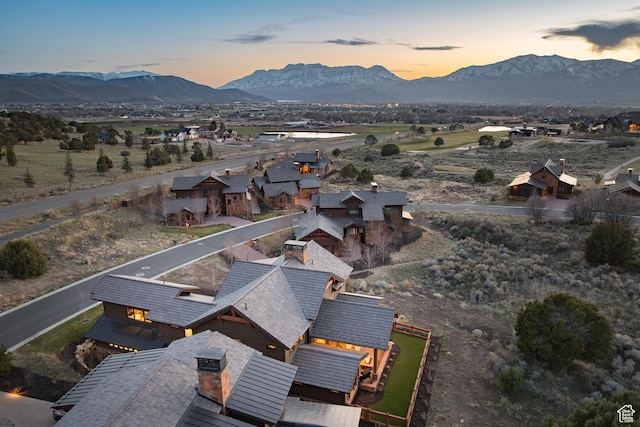 aerial view at dusk featuring a mountain view