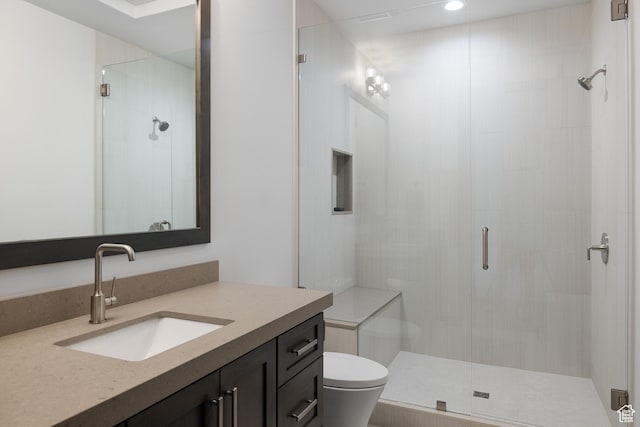 bathroom with toilet, a stall shower, vanity, and recessed lighting