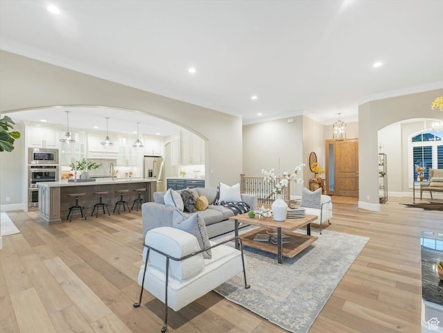 2219 E Fair Winns Ln, Draper, UT 84020 - living room featuring arched walkways, ornamental molding, recessed lighting, light wood finished floors, and baseboards