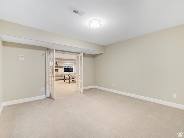 2219 E Fair Winns Ln, Draper, UT 84020 - finished below grade area with french doors, visible vents, baseboards, and light colored carpet