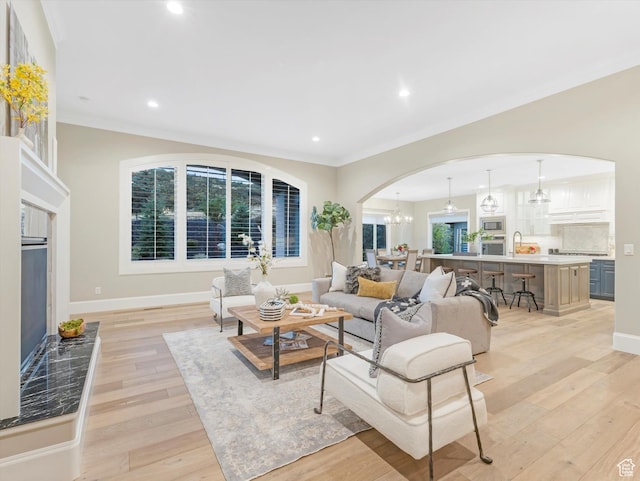 2219 E Fair Winns Ln, Draper, UT 84020 - living room featuring plenty of natural light, arched walkways, light wood-style floors, and baseboards