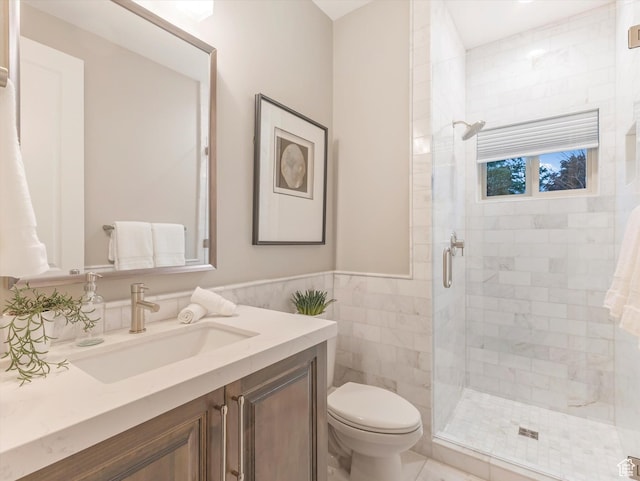2219 E Fair Winns Ln, Draper, UT 84020 - bathroom featuring vanity, toilet, wainscoting, tile walls, and a stall shower