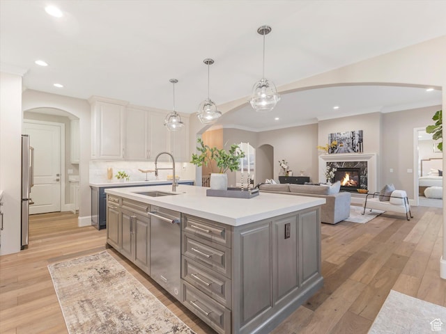 2219 E Fair Winns Ln, Draper, UT 84020 - kitchen with arched walkways, recessed lighting, a sink, stainless steel appliances, and gray cabinetry