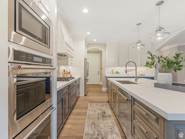 2219 E Fair Winns Ln, Draper, UT 84020 - kitchen featuring white cabinets, a sink, appliances with stainless steel finishes, recessed lighting, and light wood finished floors