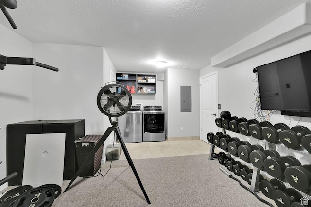 workout room with electric panel, a textured ceiling, carpet floors, washing machine and clothes dryer, and tile patterned flooring