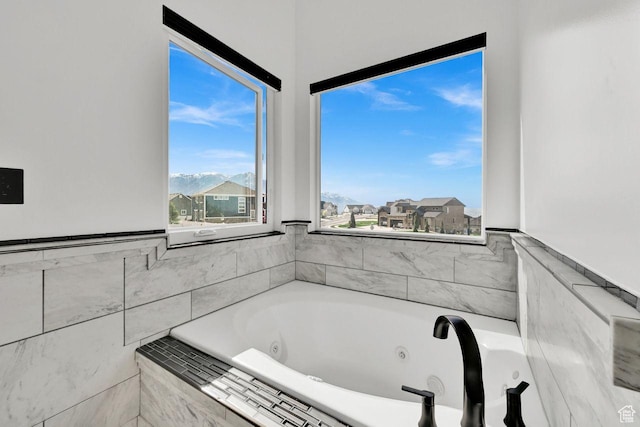 full bathroom featuring a tub with jets