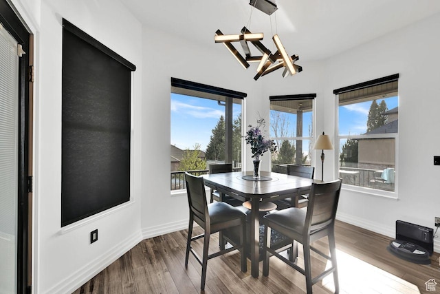 dining space featuring wood finished floors and baseboards