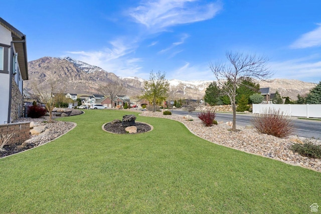 view of yard featuring a mountain view and fence