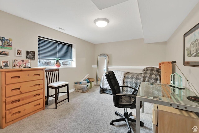 carpeted office space with visible vents and baseboards
