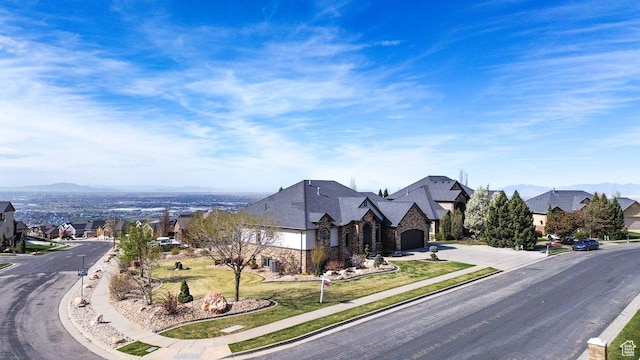 view of road with a mountain view, sidewalks, curbs, and a residential view