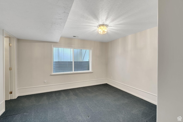 8046 W Harker Canyon Dr, Magna, UT 84044 - empty room with baseboards, dark colored carpet, and a textured ceiling