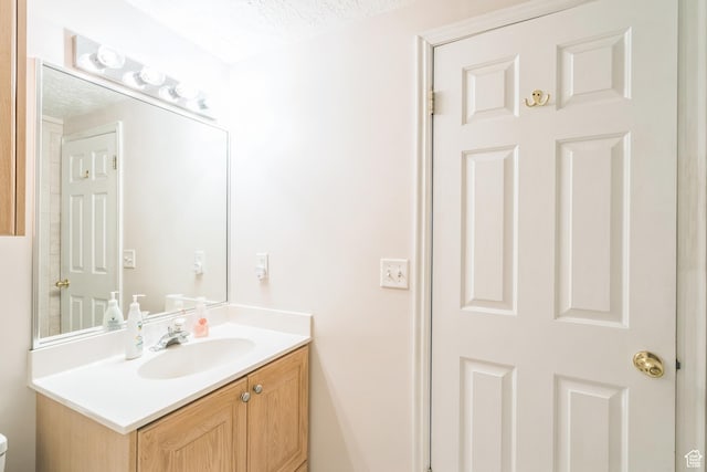 8046 W Harker Canyon Dr, Magna, UT 84044 - bathroom featuring toilet, a textured ceiling, and vanity