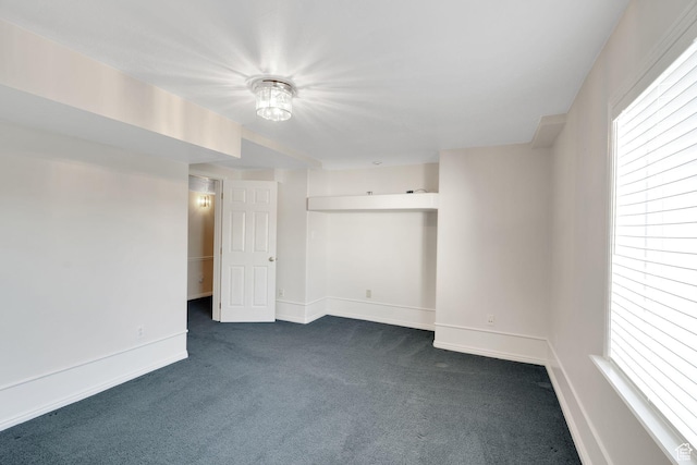 8046 W Harker Canyon Dr, Magna, UT 84044 - unfurnished room with dark colored carpet, a wealth of natural light, and baseboards
