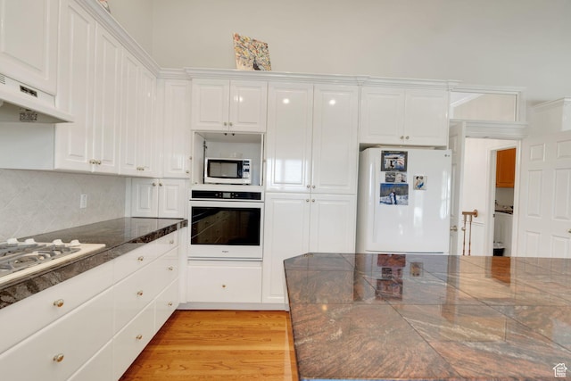 8046 W Harker Canyon Dr, Magna, UT 84044 - kitchen featuring white appliances, white cabinets, and under cabinet range hood