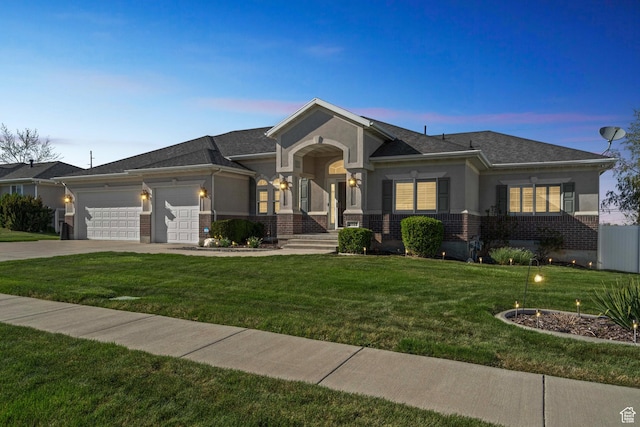 view of front of house with a yard, a garage, concrete driveway, and brick siding