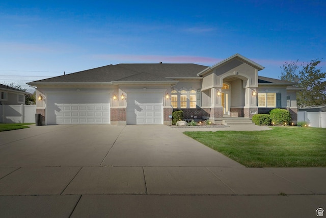 8046 W Harker Canyon Dr, Magna, UT 84044 - view of front of house featuring driveway, a lawn, an attached garage, and brick siding