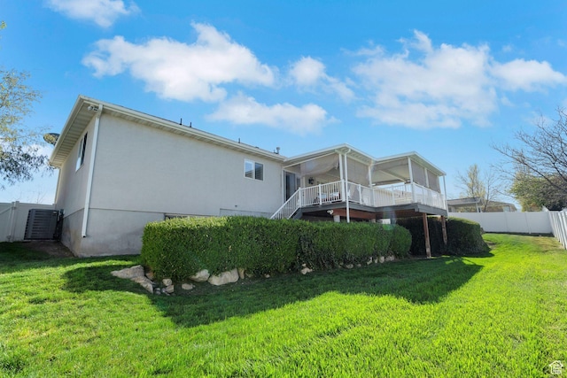 8046 W Harker Canyon Dr, Magna, UT 84044 - rear view of house featuring a deck, fence, stairs, cooling unit, and a lawn