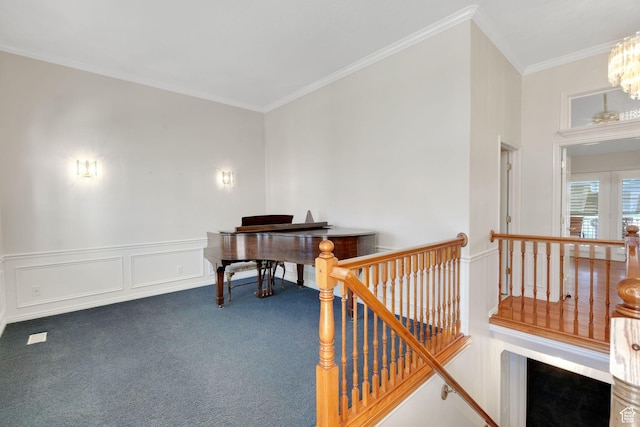 8046 W Harker Canyon Dr, Magna, UT 84044 - living area featuring carpet, a wainscoted wall, an upstairs landing, a notable chandelier, and crown molding