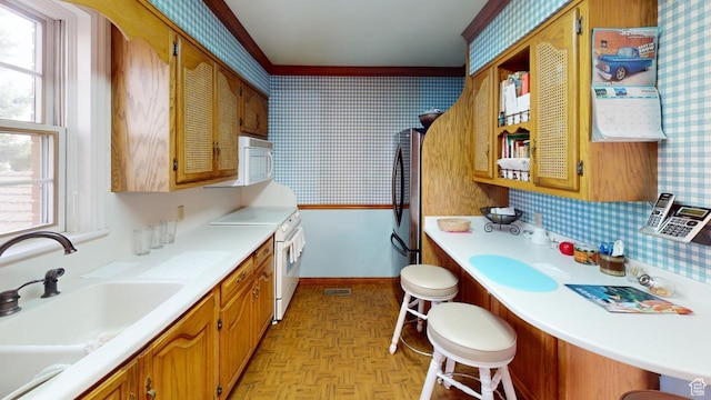1525 E 200 S, Pleasant Grove, UT 84062 - kitchen with white appliances, light countertops, a sink, wallpapered walls, and baseboards