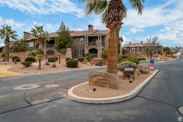 view of building exterior featuring a residential view and fence