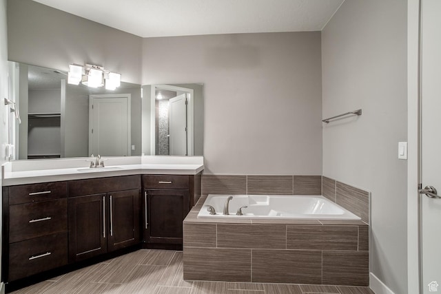 bathroom featuring vanity and a garden tub