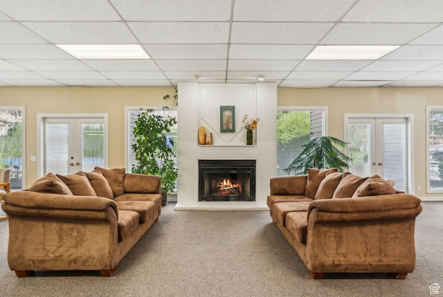 1039 E Quail Vista Ln Unit I, Salt Lake City, UT 84117 - carpeted living area featuring french doors, a paneled ceiling, and a brick fireplace