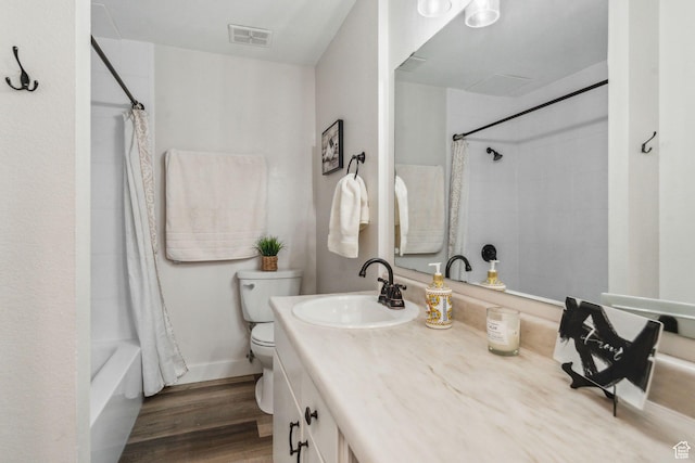 1039 E Quail Vista Ln Unit I, Salt Lake City, UT 84117 - full bath featuring visible vents, toilet, shower / bath combo with shower curtain, vanity, and wood finished floors