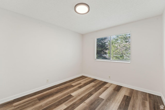 1039 E Quail Vista Ln Unit I, Salt Lake City, UT 84117 - unfurnished room with baseboards and wood finished floors
