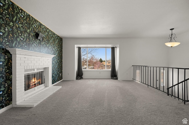 1705 E 2800 N, Layton, UT 84040 - unfurnished living room with baseboards, carpet flooring, a brick fireplace, and wallpapered walls