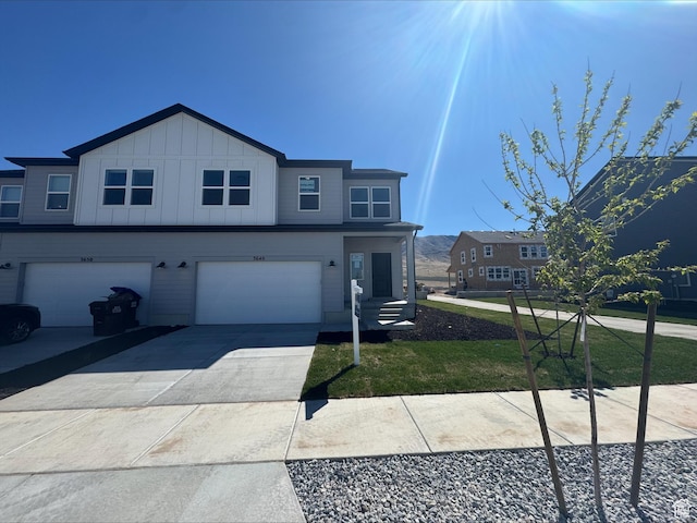 3640 N Stallion St Unit 347, Eagle Mountain, UT 84005 - view of front of property featuring an attached garage, driveway, board and batten siding, and a front yard