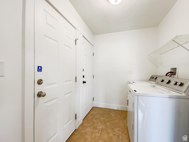 1786 E Juniper Dr, Eagle Mountain, UT 84005 - clothes washing area with light tile patterned floors, washer and clothes dryer, laundry area, and baseboards