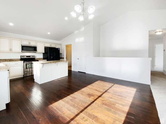 1786 E Juniper Dr, Eagle Mountain, UT 84005 - kitchen with dark wood-style flooring, light stone counters, a kitchen island, lofted ceiling, and appliances with stainless steel finishes