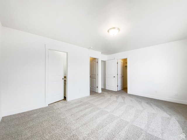 1786 E Juniper Dr, Eagle Mountain, UT 84005 - unfurnished bedroom with baseboards, a walk in closet, and carpet